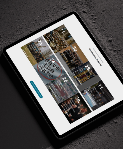 daimler-bilderreihe-3 Ein Tablet liegt auf einer rauen Oberfläche. Auf dem Bildschirm des Tablets ist die DMG-Website abgebildet.